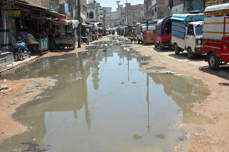 A view of sewerage water accumulated on the road at unit number 11 Latifabad