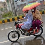 Motorcyclist on the way during heavy rain that experienced in the Provincial Capital.