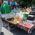 A vendor arranging and displaying Milad-un-Nabi (PBUH) related stuff to attract the customer at Aminpur Bazaar.