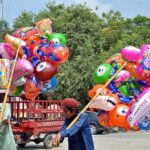 Vendors selling colorful balloons to attract children at Club road