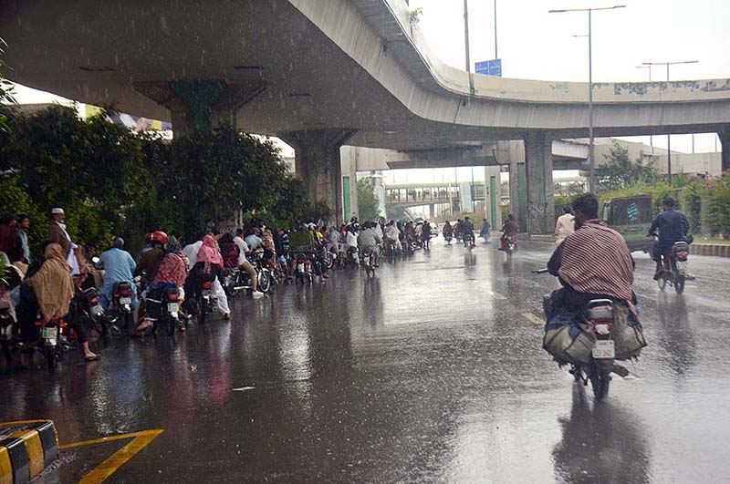 Motorcyclist on the way during heavy rain that experienced in the Provincial Capital.