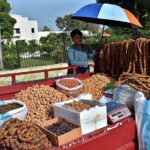 A vendor selling dry fruit in front of Company Bagh.