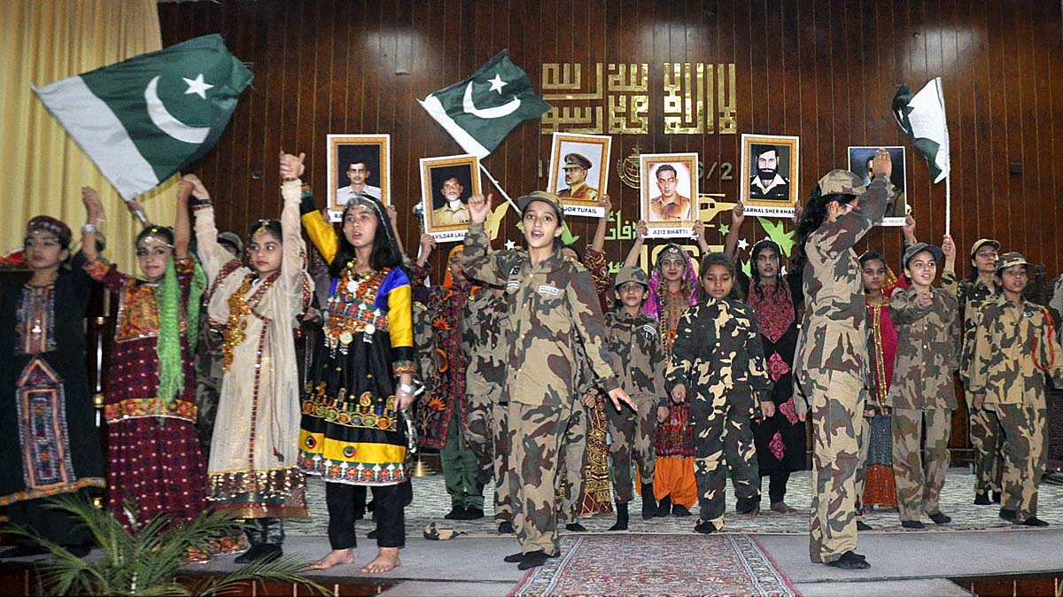 Students performing in tableau during ceremony on the occasion of Pakistan Defence Day at Islamabad Model College for Girls F-6/2.