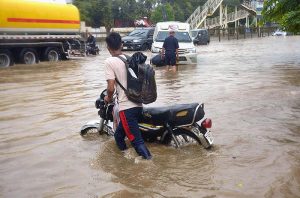 Vehicles passing through the accumulated water after heavy rain that experienced in the Provincial Capital.