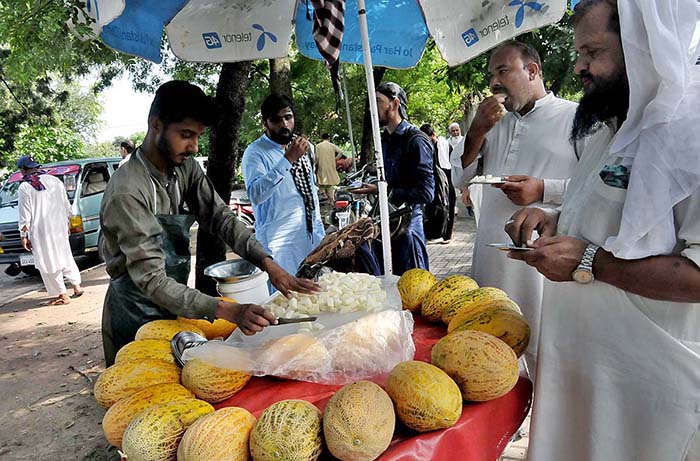 A vendor selling cantaloupe (Garma) at Aabpara Market