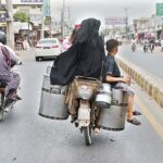 Family sitting on milk pots on the rear seat of a motorcycle in a dangerous way may cause any mishap and need the attention of concerned authorities.
