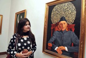 Participant viewing exhibition of paintings titled "Portraits of Quaid" organized by Ali Azmat, a renowned artist in collaboration with For Art Sake curated by Amna Pataudi and Dr. Rahat Naveed Masood at PNCA.