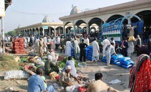 A large number of people purchasing Vegetables at Vegetable and Fruits Market.