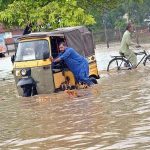 Vehicles passing through the accumulated water after heavy rain that experienced in the Provincial Capital.