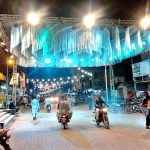 An illuminated view of road decorated with colorful lights in connection with Eid Milad-un-Nabi (PBUH) celebrations.
