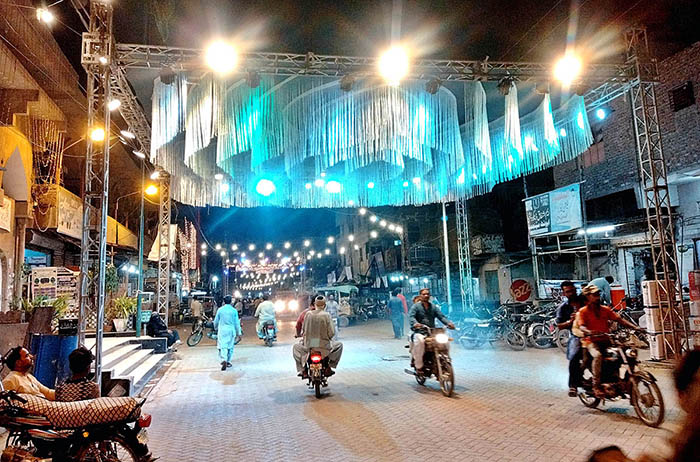 An illuminated view of road decorated with colorful lights in connection with Eid Milad-un-Nabi (PBUH) celebrations.