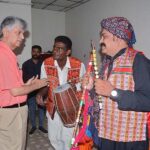 Caretaker Minister for Information and Broadcasting Murtaza Solangi talks to a folk artist after a ceremony held in his honor at Radio Pakistan Broadcasting House