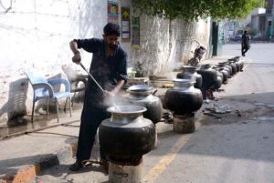 A cook preparing food to serve the participants of rally to mark birthday of the Holy Prophet Muhammad (Peace Be Upon Him) celebrating across the world