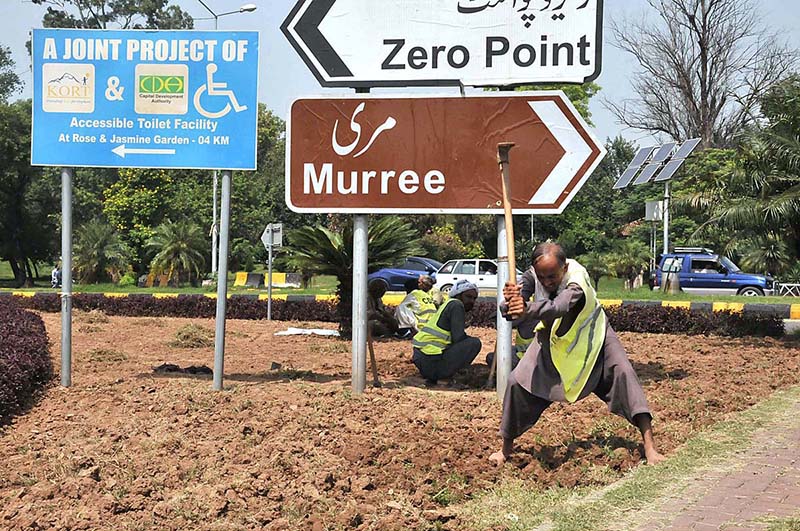 CDA gardener busy in preparing roadside greenbelt for planting flowers in Federal Capital