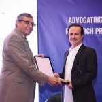 Dr. Zulfiqar Bhutta Chairman Board of Governors NIH presenting a shield to Federal Health Minister Dr. Nadeem Jan at the concluding ceremony of National Health Research Conference.