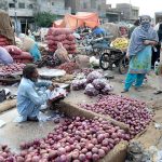 Women are buying onions from outside vendor the Vegetable Market