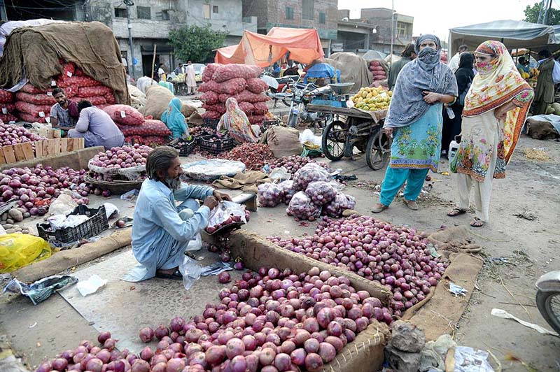 Women are buying onions from outside vendor the Vegetable Market