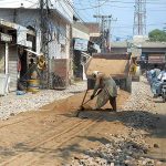 Labourers busy in construction work of Baba Safra Road during development work in the city.