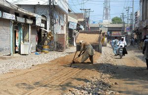 Labourers busy in construction work of Baba Safra Road during development work in the city.