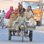 Gypsy ladies traveling on the motorcycle cart toward their destination
