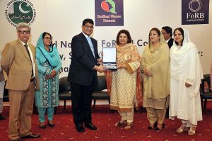 Muhammad Zia-ul-Haq, Director General Islamic Research Institute, International Islamic University giving shield to participant during closing session of Second National FoRBLN conference Inclusivity ,social Cohesion and Diversity Challenges the way forward organized by Resilient Women Network.