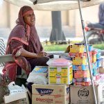 A women vendor selling traditional stuff along roadside.