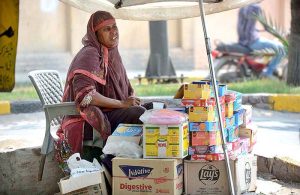 A women vendor selling traditional stuff along roadside.