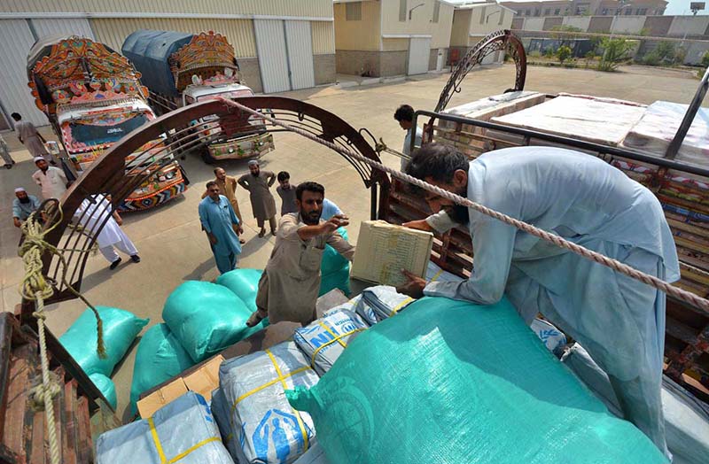 Labours are loading relief items in a truck that would be send to affectees of Jaranwala incident by Secretary Auqaf, Hajj, Religious & Minority Affairs KP Dr. Asad Ali Khan