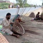 Gypsy family making baskets from dry tree branches at roadside setup