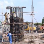 Workers engaged in construction work on six lane overhead bridge of Shahdara N-5 Crossing near Imamia Colony