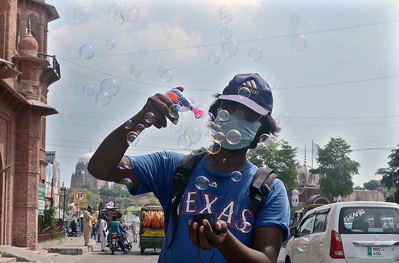 A Vendor displaying and selling bubble gun for Kids at Ghanta ghar chowk