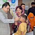 Commissioner Amir Khattak is administering Polio drops to a child during Anti-Polio Campaign at Shahbaz Sharif Hospital