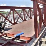 Worker busy in fixing the overhead pedestrian bridge at IJP road.