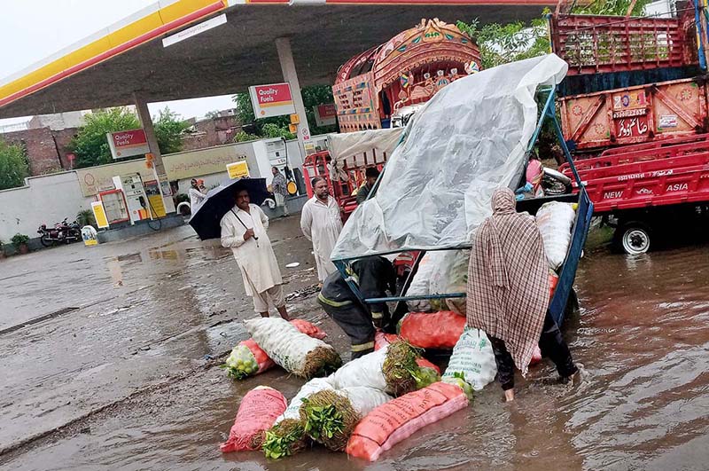 A loader rickshaw Turn Turtle due to overloaded during passing through the accumulated water near sabzi mandi after heavy rain that experienced in the Provincial Capital.