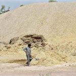 Labourer is arranging husk from wheat at his workplace