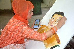 Student giving final touch to her painting regarding Defence day at Bab-e-Pakistan Walton Road