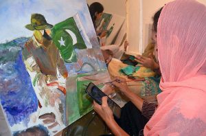 Student giving final touch to her painting regarding Defence day at Bab-e-Pakistan Walton Road