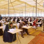 Student solving question paper during pre-entry test for admission in the LUMHS International Medical & Technical College.