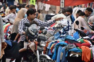 A street vender displaying used laptops to attract the customers at his road side setup