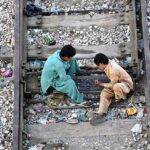 Youngster playing traditional game on railway tracks near Railway Station