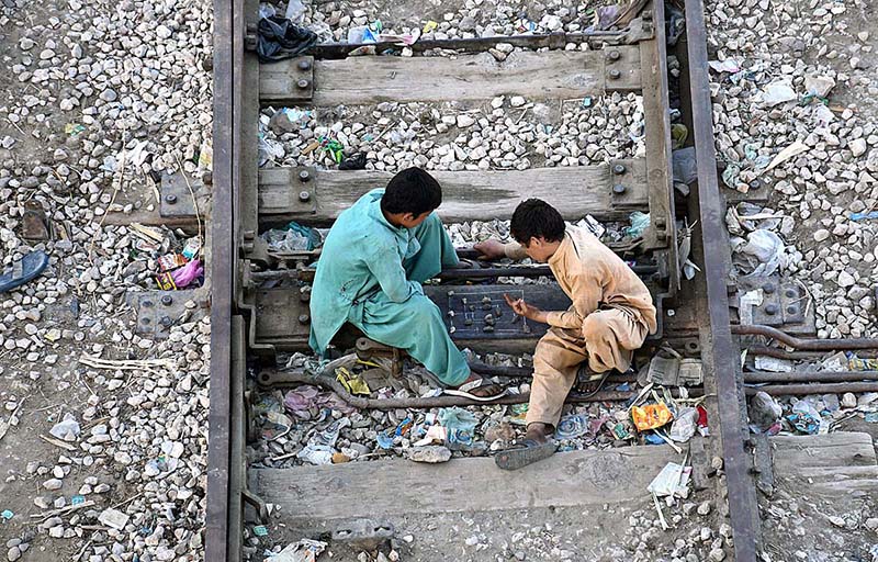 Youngster playing traditional game on railway tracks near Railway Station