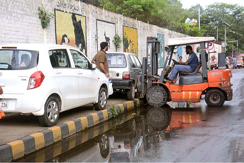 Traffic police warden removing wrong parked vehicle on footpath