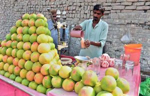  A vendor extracting juice for customers at Railway Station Road. 