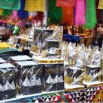 A young vendor displaying the Holly Kaaba model and different kind of decoration stuff at Urdu Bazar in connection with Eid-e-Milad-un-Nabi (SAWW) celebrations.
