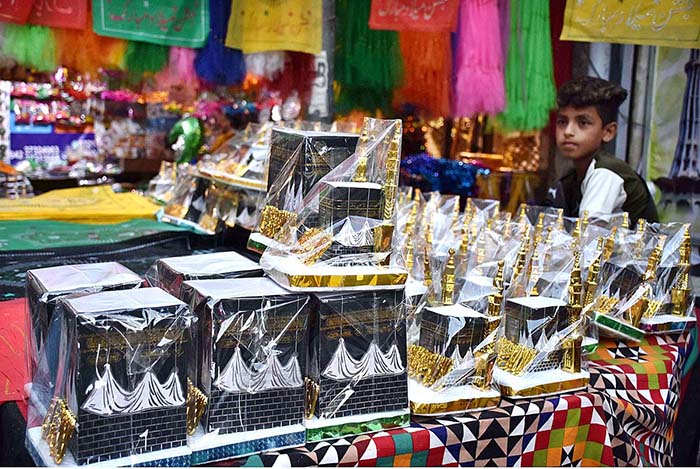 A young vendor displaying the Holly Kaaba model and different kind of decoration stuff at Urdu Bazar in connection with Eid-e-Milad-un-Nabi (SAWW) celebrations.