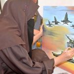 Student Painter giving final touch to her artwork on the upcoming occasion of Defence Day at Arts Council Alhamra Art Gallery