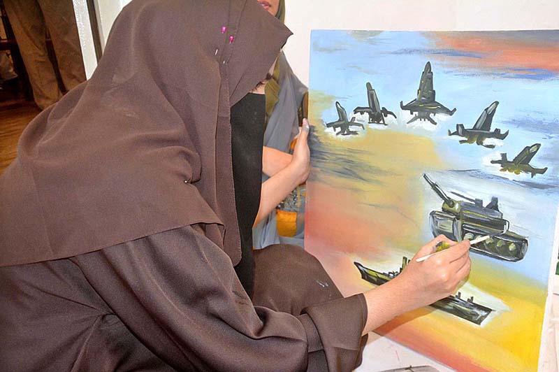 Student Painter giving final touch to her artwork on the upcoming occasion of Defence Day at Arts Council Alhamra Art Gallery
