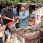 A vendor selling roasted corn cobs to customer in Provincial Capital