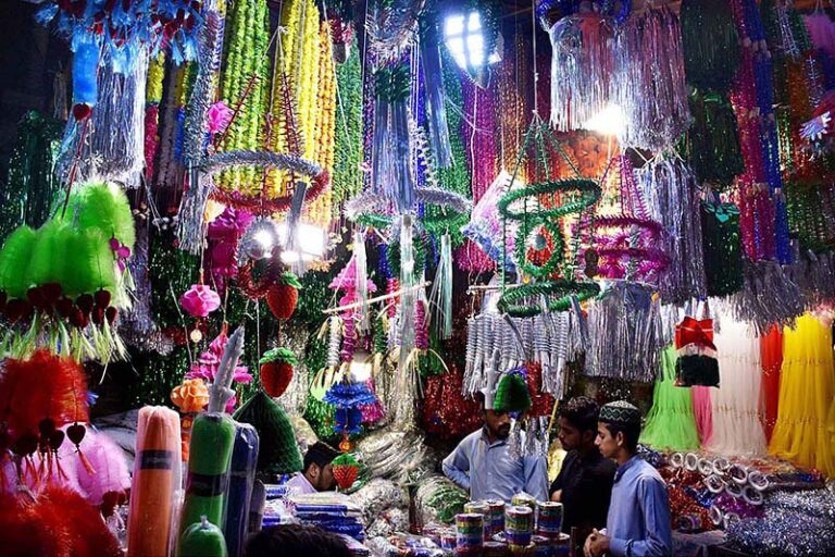 A man carrying the decorated Makkah sculpture at Urdu Bazar in