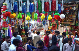 A young vendor displaying the Holly Kaaba model and different kind of decoration stuff at Urdu Bazar in connection with Eid-e-Milad-un-Nabi (SAWW) celebrations.